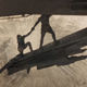 Gurney Halleck pulls Paul Atreides onto a ship's ramp as a giant sandworm devours a spice facility.
